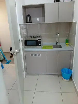 a kitchen with a sink and a microwave at Sky Residence at TRION KL in Kuala Lumpur