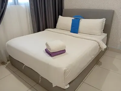 a bed with two towels on top of it at Sky Residence at TRION KL in Kuala Lumpur