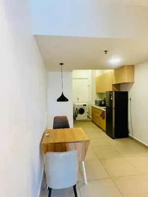 a kitchen with a wooden table and a refrigerator at Sky property infinitum 2 in Kuala Lumpur