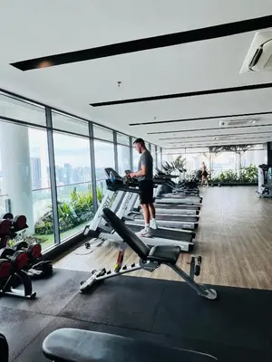 a man standing in a gym with cardio machines at Sky property infinitum 2 in Kuala Lumpur