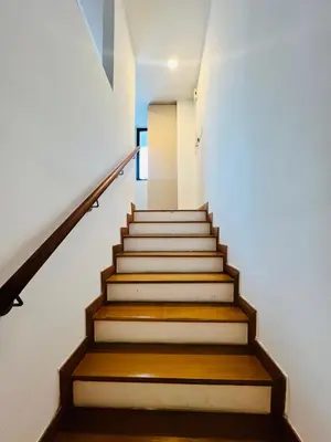 a staircase in a building with white walls and wooden floors at Sky property infinitum 2 in Kuala Lumpur