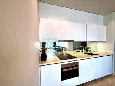 a kitchen with white cabinets and a sink at Sky Suites Klcc By Bukit Bintang in Kuala Lumpur