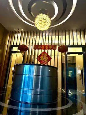 a large blue barrel in a lobby with a chandelier at Sky Suites Klcc By Bukit Bintang in Kuala Lumpur