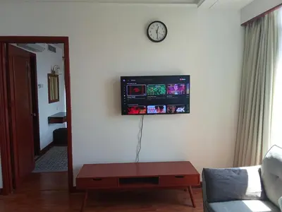 a living room with a tv on a wall at BTS Service suite at time square in Kuala Lumpur