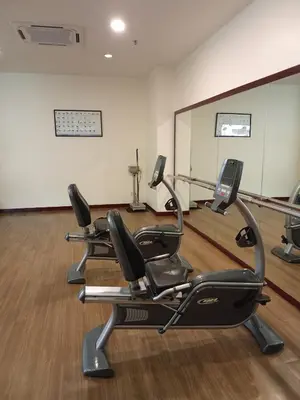 a gym with three exercise bikes in a room at BTS Service suite at time square in Kuala Lumpur