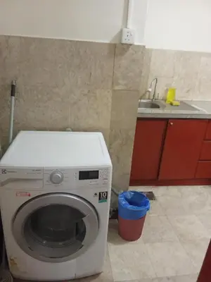 a washing machine in a kitchen with a sink at BTS Service suite at time square in Kuala Lumpur