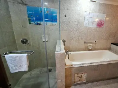 a bathroom with a bath tub and a shower stall at Time square midnight suites KL in Kuala Lumpur
