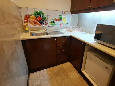 a kitchen with a sink and a microwave at Time square midnight suites KL in Kuala Lumpur