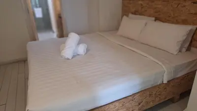 a bed with two rolls of towels on it at Time square midnight suites KL in Kuala Lumpur