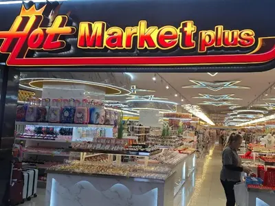 a woman standing in front of a supermarket counter at Time square midnight suites KL in Kuala Lumpur