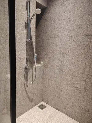 a shower with a shower head in a bathroom at Scarletz Suites KLCC by near twin tower in Kuala Lumpur