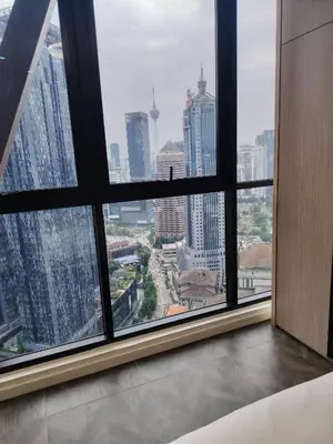 a room with a view of a city from a window at Scarletz Suites KLCC by near twin tower in Kuala Lumpur