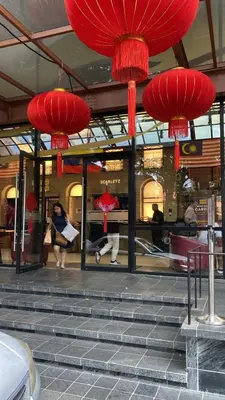 a group of red lanterns hanging above stairs in a building at Scarletz Suites KLCC by near twin tower in Kuala Lumpur
