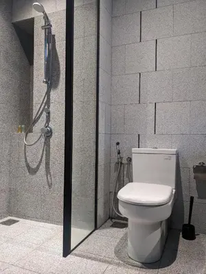 a bathroom with a shower with a toilet and a shower at Alion Sutis KLCC At Scarlets in Kuala Lumpur