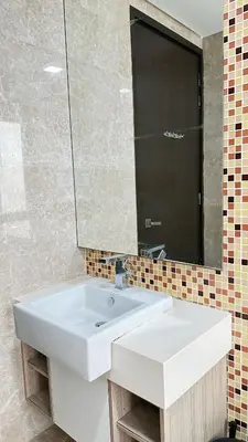 a bathroom with a white sink and a mirror at 3BR family friendly Apartment at The Elements Ampang Kuala Lumpur in Kuala Lumpur