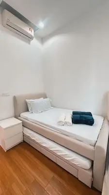 a small bed in a room with a white wall at 3BR family friendly Apartment at The Elements Ampang Kuala Lumpur in Kuala Lumpur