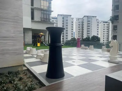 a black vase sitting on a chessboard in a courtyard at 3BR family friendly Apartment at The Elements Ampang Kuala Lumpur in Kuala Lumpur