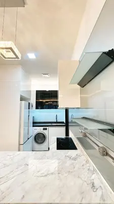 a white kitchen with a washing machine in it at 3BR family friendly Apartment at The Elements Ampang Kuala Lumpur in Kuala Lumpur