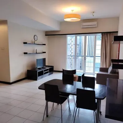 a living room with a table and chairs and a couch at Abadi Inn in Kuala Lumpur