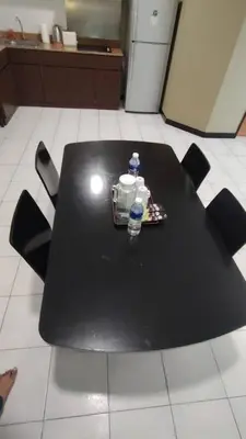 a black table with a bottle of water on it at Abadi Inn in Kuala Lumpur