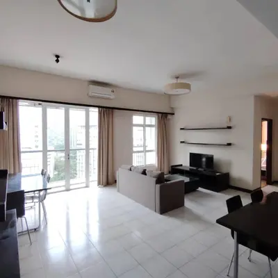 a living room with a couch and a table at Abadi Inn in Kuala Lumpur