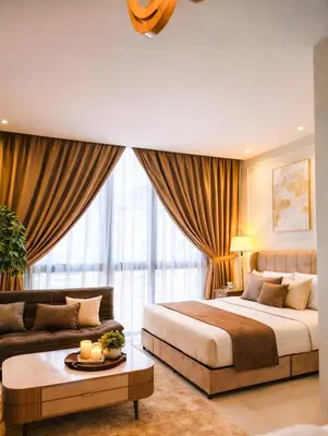 a bedroom with a large bed and a couch at Rooftop Pool At Majestic Residence in Kuala Lumpur