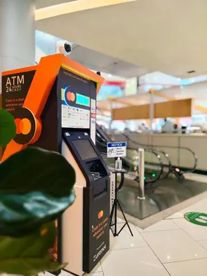 an atm machine in an airport with an orange handle at Rooftop Pool At Majestic Residence in Kuala Lumpur