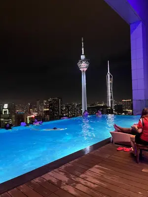 a pool at night with a view of the space needle at Oras Suites At platinum KLCC in Kuala Lumpur