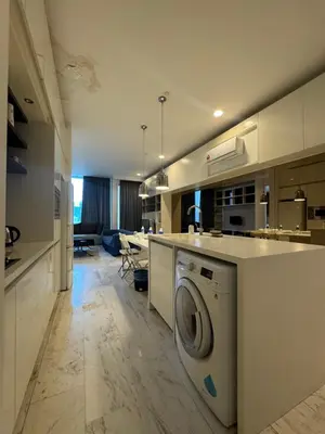 a kitchen with a washing machine in the middle at Oras Suites At platinum KLCC in Kuala Lumpur