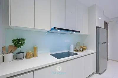a kitchen with white cabinets and a blue light at Met 1 Mont Kiara - 3 min to Publika Mall - 2B2B for 4 in Kuala Lumpur