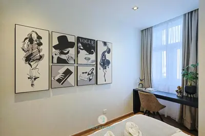 a bedroom with pictures of women on the wall at Met 1 Mont Kiara - 3 min to Publika Mall - 2B2B for 4 in Kuala Lumpur