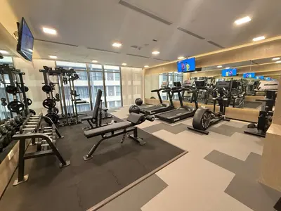 a gym with several treadmills and machines in it at KLCC VIEW RESIDENC, I M P E R I A L , By LUXORA in Kuala Lumpur