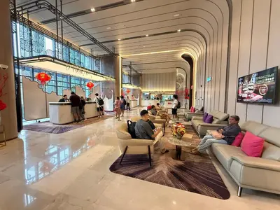 a lobby with people sitting on couches in a building at KLCC VIEW RESIDENC, I M P E R I A L , By LUXORA in Kuala Lumpur