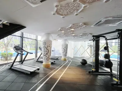 a gym with exercise equipment in a room with windows at Arte mont kiara by stayhold apartment in Kuala Lumpur