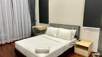 a bedroom with a white bed with a chair at Dreamy KLCC Luxury Haven in Kuala Lumpur