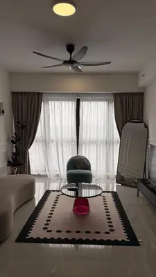 a living room with a ceiling fan and a table at Agile Residence Sky View Suites in Kuala Lumpur