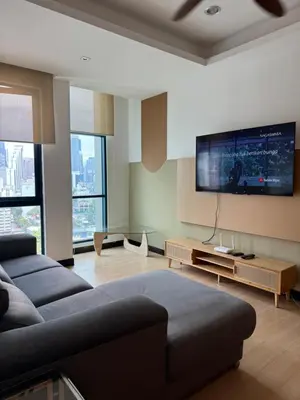 a living room with a couch and a flat screen tv at Bukit Bintang Casa By Eryan Guest House in Kuala Lumpur