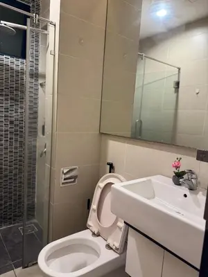 a bathroom with a toilet and a sink and a shower at Bukit Bintang Casa By Eryan Guest House in Kuala Lumpur