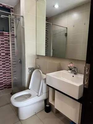 a bathroom with a toilet and a sink and a mirror at Bukit Bintang Casa By Eryan Guest House in Kuala Lumpur
