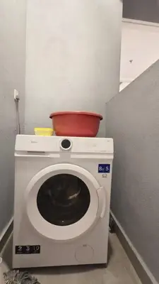 a washing machine with a bowl on top of it at Trion Kuala Lumpur in Kuala Lumpur