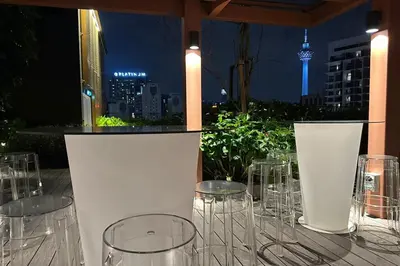 a table with wine glasses and a view of a city at Majestic Residence KLCC by Luxe in Gua Sai