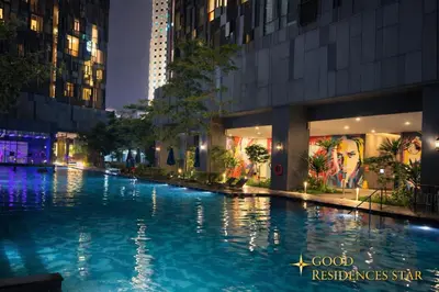 a pool in the middle of a city at night at Good Residences at Star KLCC in Kuala Lumpur