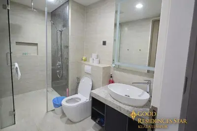 a bathroom with a toilet and a sink and a shower at Good Residences at Star KLCC in Kuala Lumpur