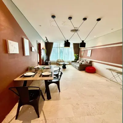 a living room with a table and chairs and a couch at Sky suites klcc by Ryan in Kuala Lumpur