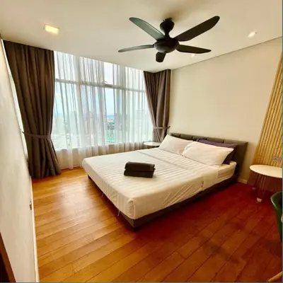 a bedroom with a bed with a ceiling fan at Sky suites klcc by Ryan in Kuala Lumpur