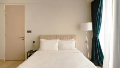 a bedroom with a bed with a blue curtain at Star KLCC Cosy Twin Tower Suite 2-3pax in Kuala Lumpur