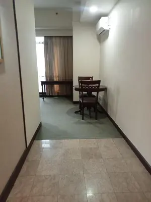 a hallway with a table and chairs in a room at GMS suites in Kuala Lumpur