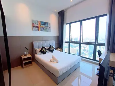 a bedroom with a white bed with a large window at The Wisma Infinitum KLCC By Kuala Lumpur City in Kuala Lumpur