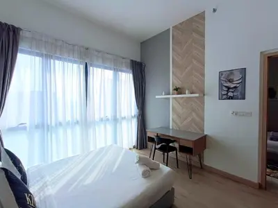 a bedroom with a bed and a desk and a window at The Wisma Infinitum KLCC By Kuala Lumpur City in Kuala Lumpur