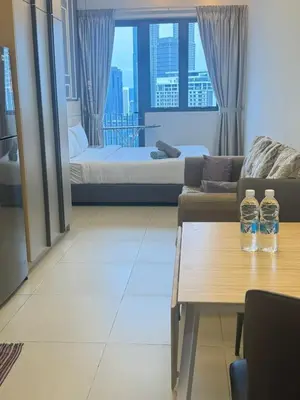 two water bottles on a coffee table in a living room at The Wisma Infinitum KLCC By Kuala Lumpur City in Kuala Lumpur